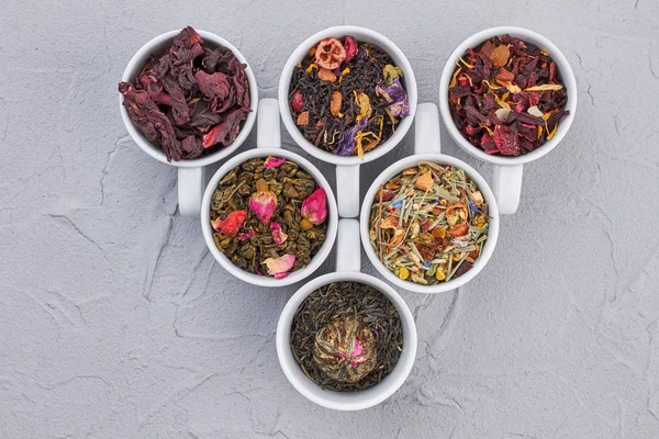 Flat lay composition with different types of dry tea leaves. — Stock Photo, Image