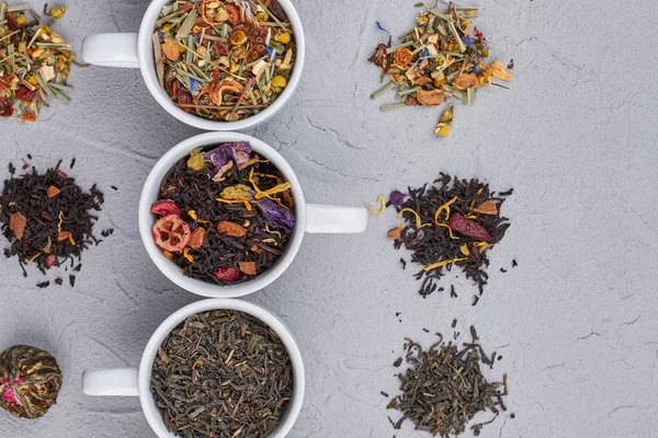 Aromatic dry tea on gray background. — Stock Photo, Image