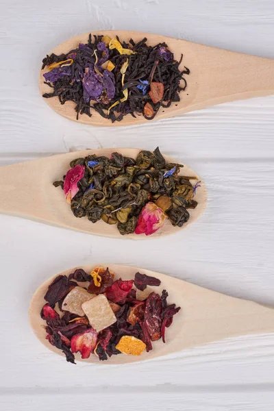 Assortment of dry tea in wooden spoons. — Stock Photo, Image