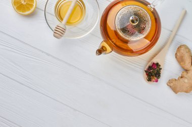 Ahşap masa üzerinde bal ve limon ile çaydanlık.