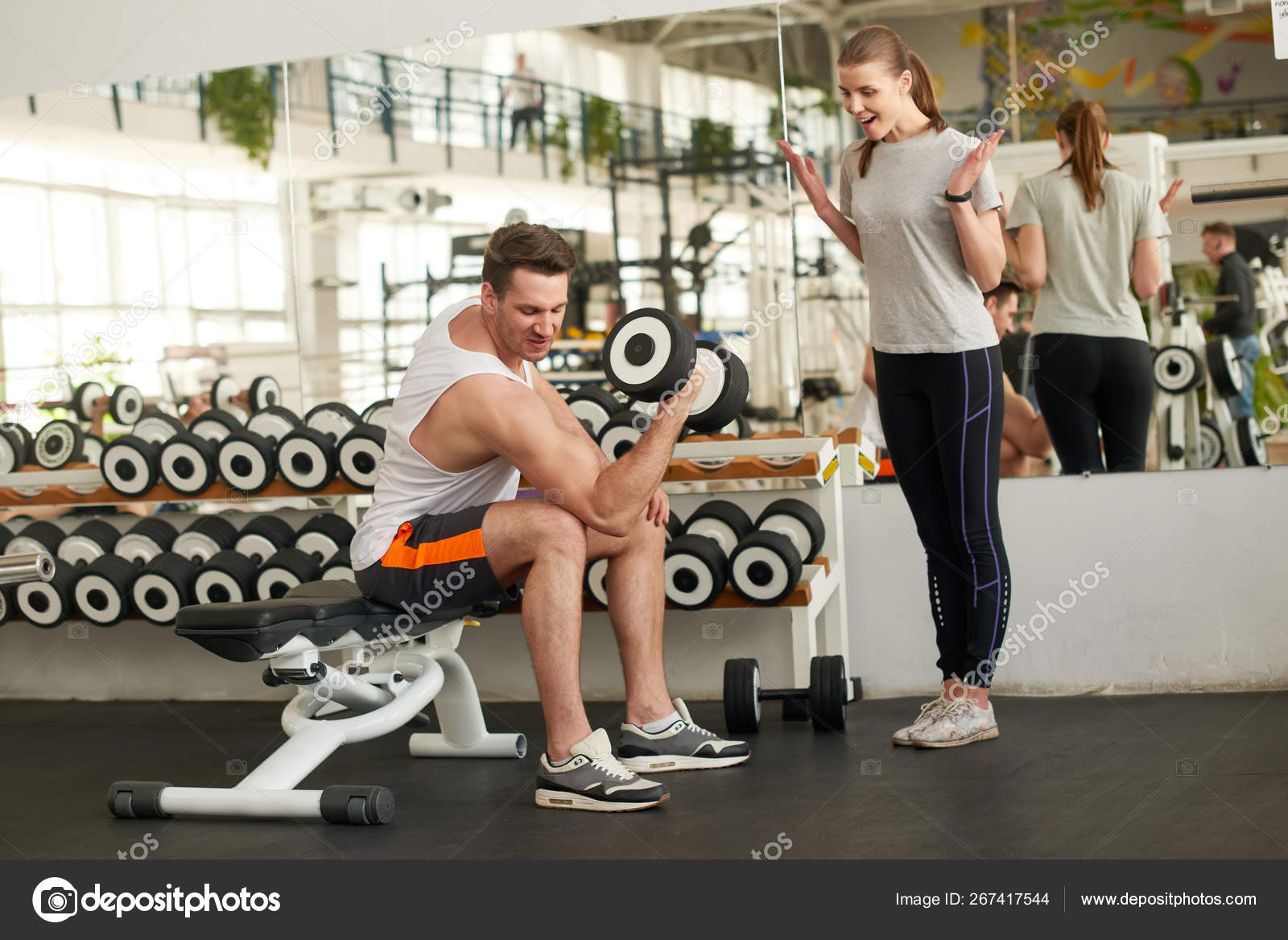 homme sportif s'entraînant avec haltère dans la salle de gym