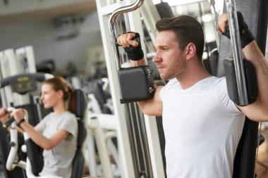 Young handsome man training at gym.