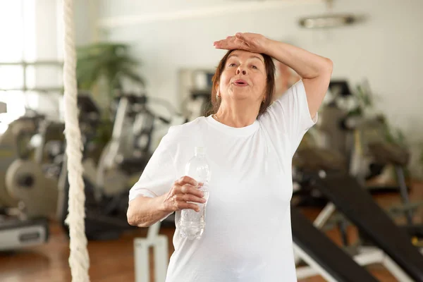 Tired senior woman at gym. — Stock Photo, Image