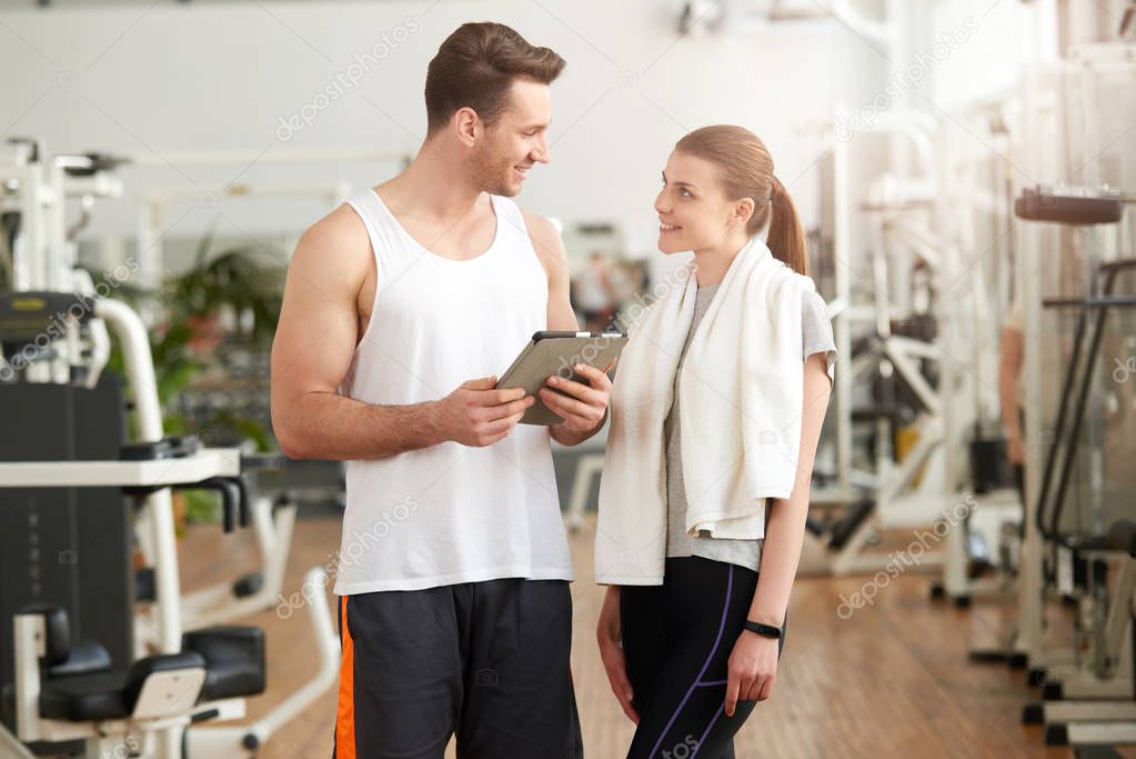 Man and woman looking at each other in gym.