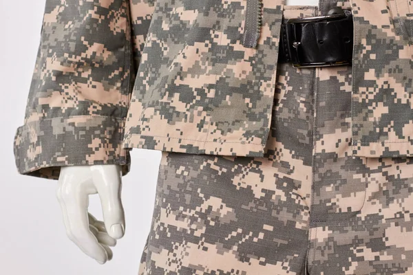 Military camouflage clothes and belt on mannequin.