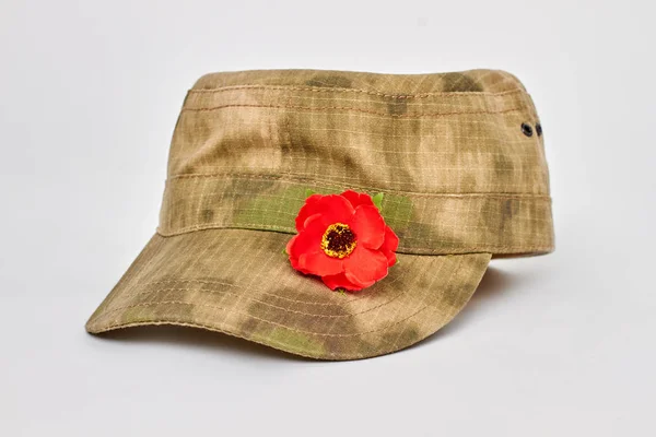 Military cap with red popper. — Stock Photo, Image