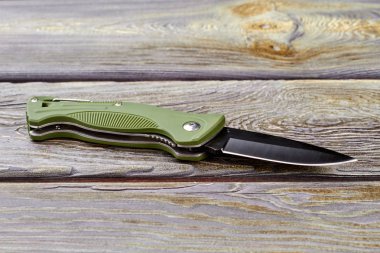 Jackknife on wood, close up. clipart