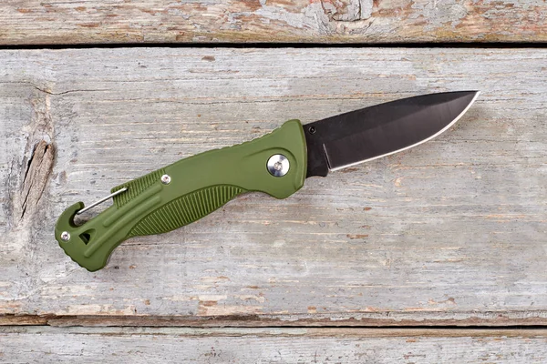 Army pocket knife with green handle.
