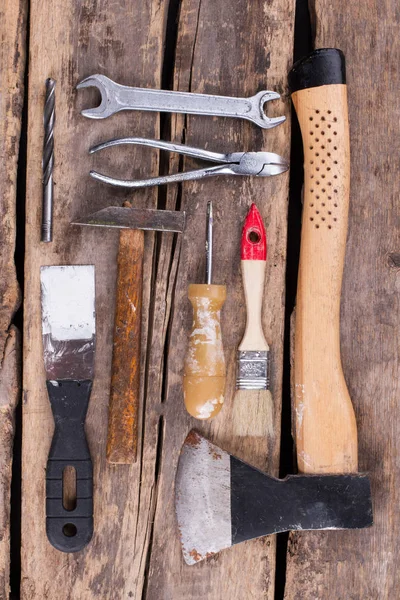 Old rusty tools on a wooden boards background. — Stock Photo, Image