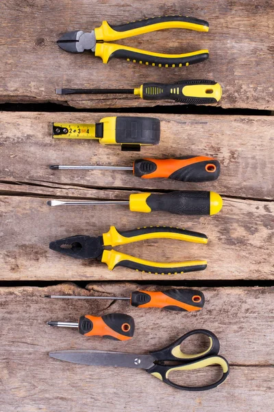 Construction tools set on old wooden background.