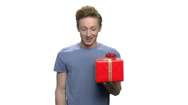 Shy boy giving gift box. — Stock Video