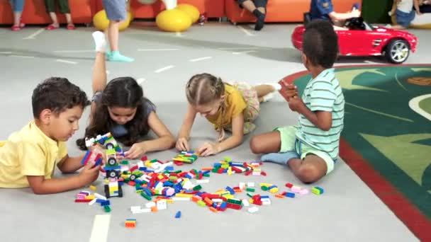 Grupo de niños jugando con juguetes de bloque . — Vídeo de stock