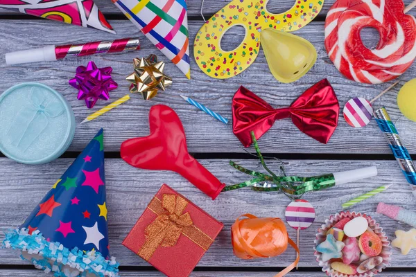 Carnival decorations on wooden background.