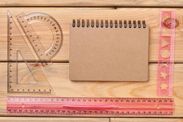 Flat lay of plastic rulers and spiral notebook. — Stock Photo, Image
