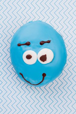 Mavi kağıt arka plan üzerinde komik donut.