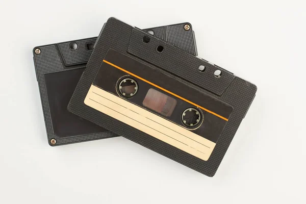 Two black cassettes on white background. — Stock Photo, Image