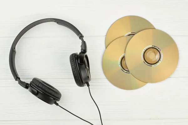 Black headphones and compact discs.
