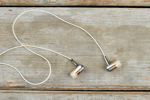 Auriculares grises sobre fondo de madera viejo . —  Fotos de Stock