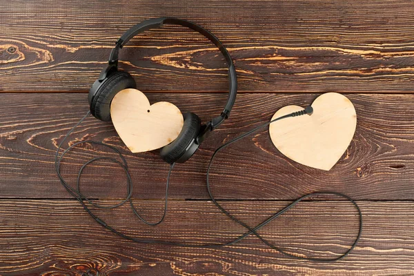 Headphones and two wooden hearts. — Stock Photo, Image