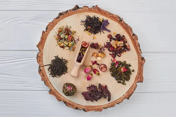 Ahşap dilim üzerinde kuru çay çeşitleri, üst görünümü.