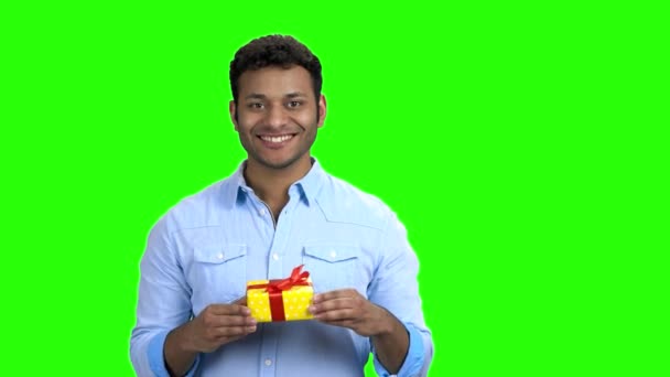 Handsome man giving gift box on green screen. — Stock Video