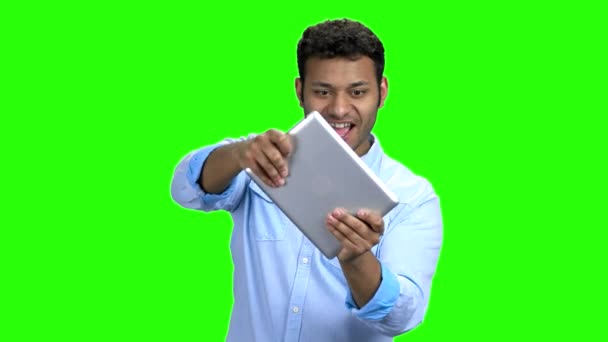 Funny Indian guy playing game on digital tablet. — Stock Video