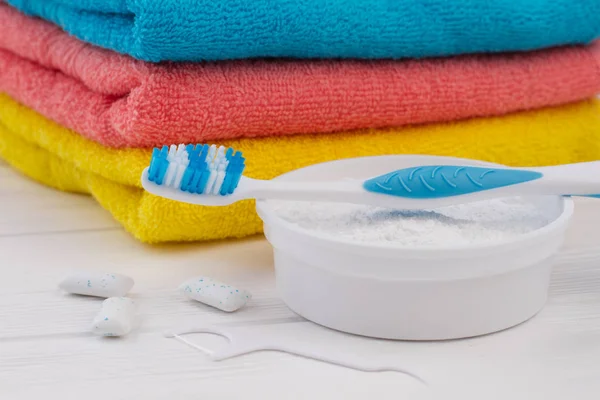 Toothbrush, cleaning powder, dental floss and towels.