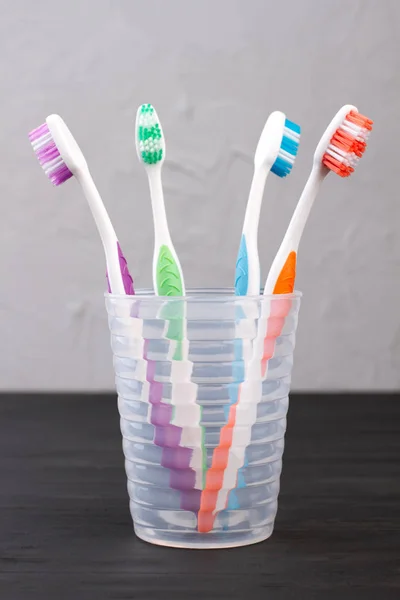 Set of toothbrushes in glass. — Stock Photo, Image