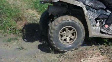 Man riding ATV or quad in the mud.