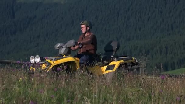 Man riding on quad bike in mountains. — Stockvideo