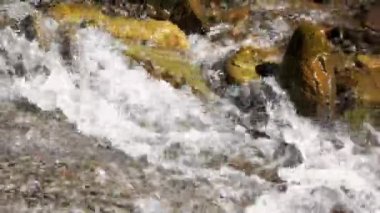 Taşların üzerinde güçlü bir su akışı var..