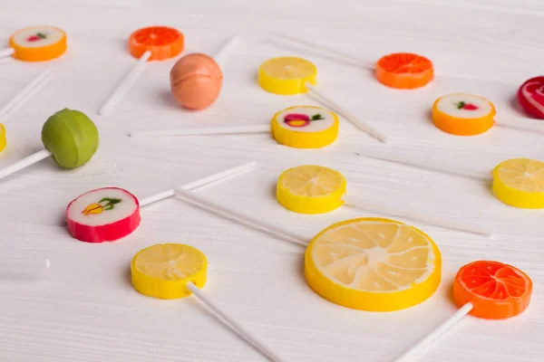 Fruit shaped lollipops on wooden background. — Stock Photo, Image