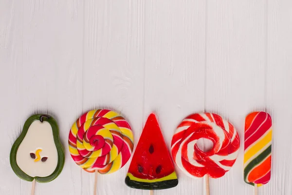 Border from large assorted lollipops. — Stock Photo, Image