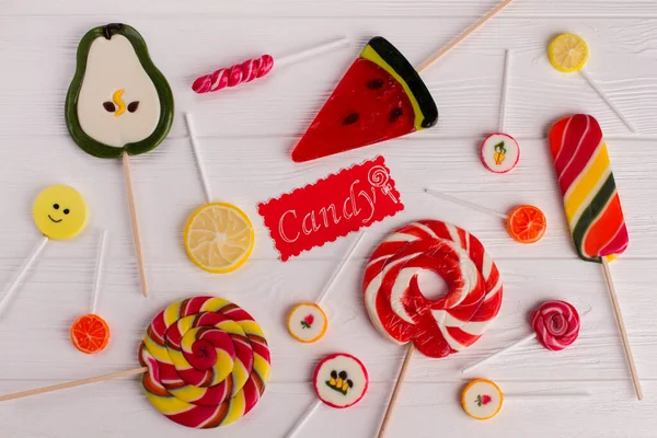 Assortment of colorful lollipops on wooden background. — Stock Photo, Image