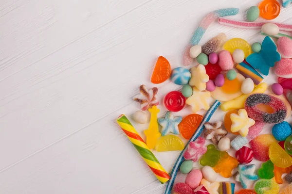 Sweet candies on white wooden background. — Stock Photo, Image