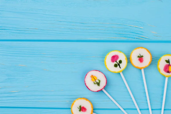 Composition from candies on blue background. — Stock Photo, Image