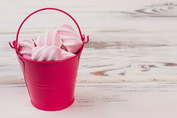 Small red bucket with marshmallows.