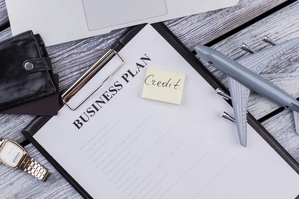 Clipboard with business plan and credit note.