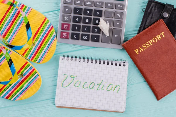 Top view of passport, sandals, calculator on table meaning for plan to travel in vacation. — Stock Photo, Image