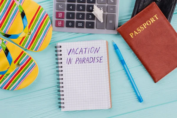 Vacation in paradise written on notebook, flip-flops and passport. — Stock Photo, Image