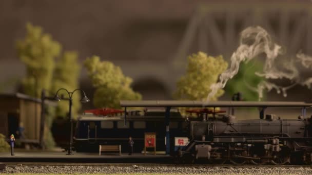 Model parní vlak projíždí stanicí zblízka. — Stock video