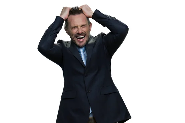 A middle-aged businessman is going crazy trying to tear his hair. — Stock Photo, Image