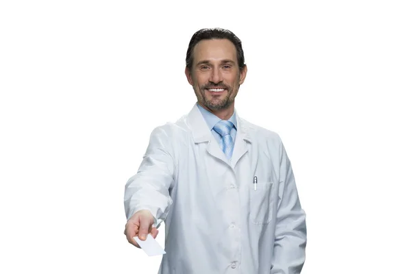 Sorrindo médico maduro está dando um cartão . — Fotografia de Stock