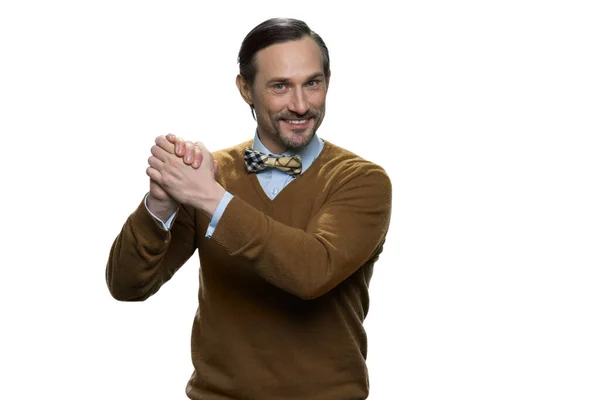 Smiling mature man in sweater is doing a support gesture. — Stock Photo, Image