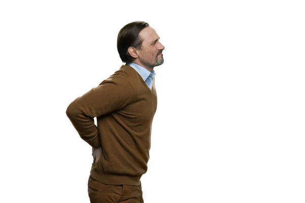 Middle-aged man touching his lower back. — Stock Photo, Image