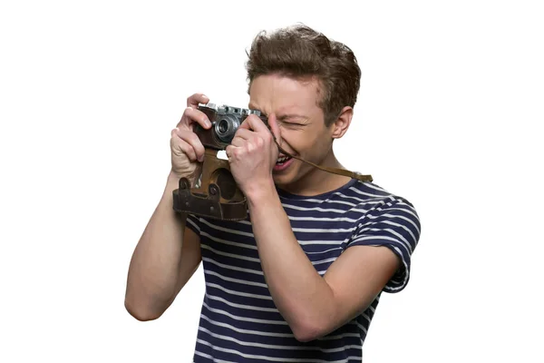 Young teenage boy with vintage camera is taking a photo. — Stock Photo, Image