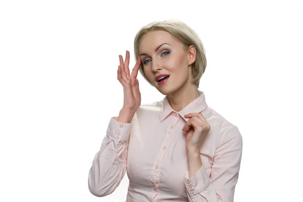 Confident attractive blond woman in white blouse against white background. — Stock Photo, Image