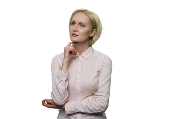 Serious blonde woman in white blouse look upwards thoughtfully and happily on white background. — Stock Photo, Image