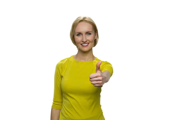 Smiling young woman in yellow turtleneck showing OK sign with his thumb up on white background. — Stock Photo, Image