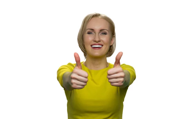 Smiling girl making thumbs up sign with both hands on white background. — Stock Photo, Image